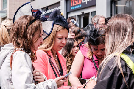 Epsom Surrey, London UK, June 04 2022, Three Women Buying tickets From A Street Seller On Crowded Streetのeditorial素材