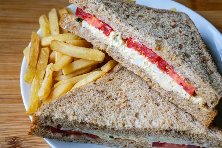 London UK, July 14 2025, Freshly Made Egg and Tomato Sandwich With Salad Cream And Chips Or Friesの写真素材