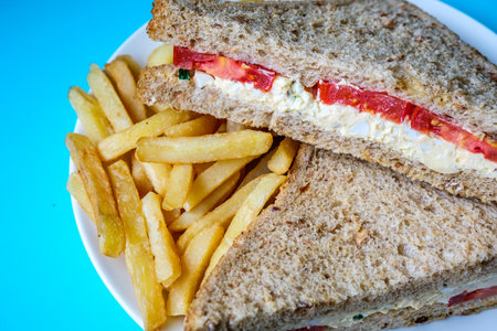 London UK, July 14 2025, Freshly Made Egg and Tomato Sandwich With Salad Cream And Chips Or Fries