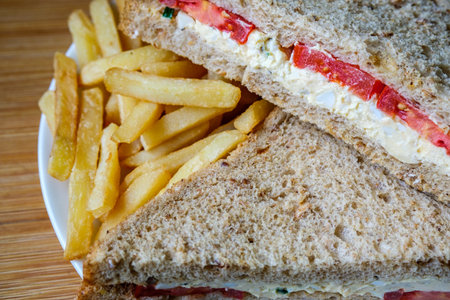 London UK, July 14 2025, Freshly Made Egg and Tomato Sandwich With Salad Cream And Chips Or Fries