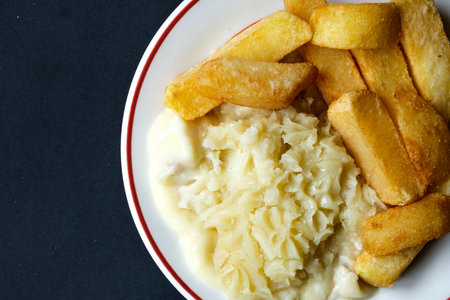 London UK, June 24 2025,  Traditional Classid Baked Fish Pie with THick Cut Chunky Chips