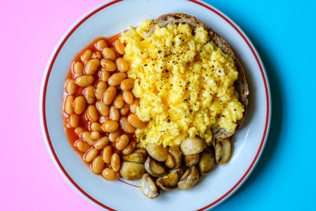 London UK June 25 2025,  Scrambled Eggs Fried Mushrooms Baked Beans and Tomato Sauceの写真素材