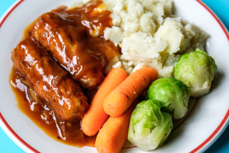 London UK, June 24 2025, Classic Bangers And Mash With Carrots and Brussel Sprouts Vegetables