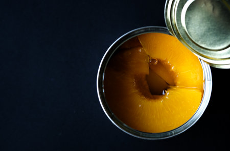London UK, June 06 2025, Open Tin Or Can Of Sliced Peaches Dessert Or Cooking Ingredientsの写真素材