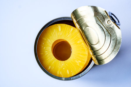 London UK, June 06 2025, Open Tin Or Can Of Healthy Pineapple Rings Tropical Fruit