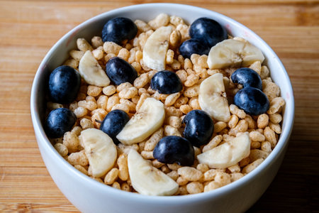 London UK, June 12 2025, Bowl Of Classic Rice Krispies Breakfast Cereals With Fresh Blueberries And...