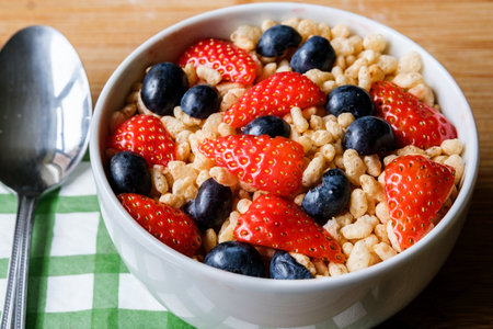 London UK, June 12 2025, Bowl Of Classic Rice Krispies Breakfast Cereals With Fresh Strawberries And...