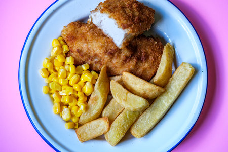 London UK, September 05 2025,  Breaded Chicken Fillets With Chunky Chips And Sweetcornの写真素材