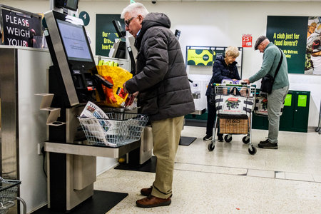 London UK, April 02 2026, Single Senior Man Paying For Shopping at Automated Self Service Checkout...