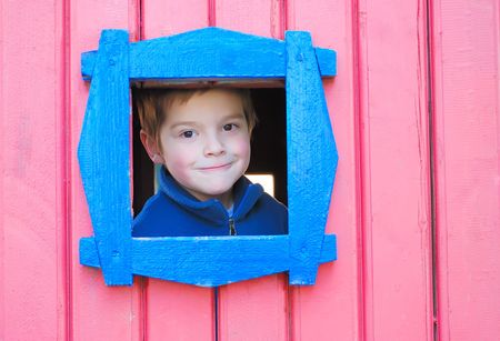 boy in a small pink houseの写真素材