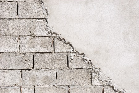 Unfinished wall made of concrete blocks covered with mortar