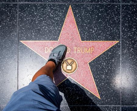Los Angeles, USA - August 5, 2016: Man stepping on Donald Trump Star before it was damaged at Walk of Fame on Hollywood Boulevard, Los Angeles, on August 5th 2016.のeditorial素材
