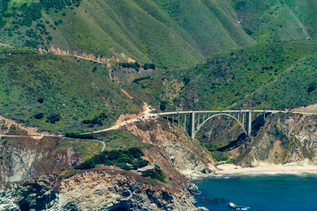 Bixby Creek Bridge on Highway 1 in California seen from the plane on a sunny day.