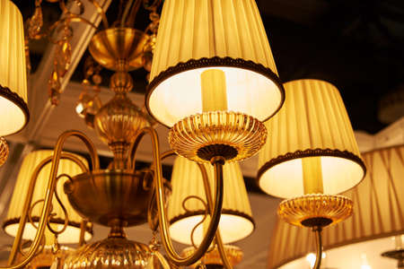 Many gilt beautiful chandeliers hanging from the ceiling in the sales areaの写真素材