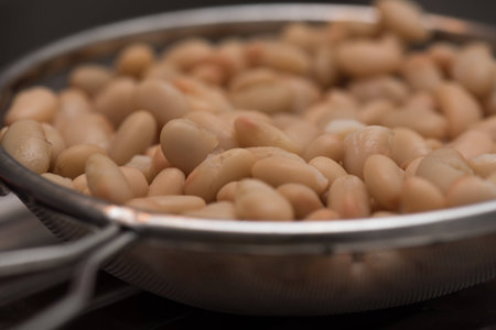 Sieve filled with beans ready to be cookedの写真素材