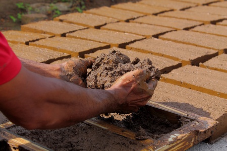 Workers will put in the mold of clay brick