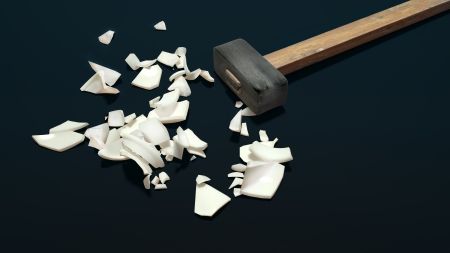 big iron hammer and porcelain broken into piecesの写真素材