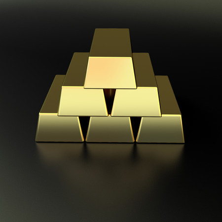 few golden bars made in a pyramid on black matted backgroundの写真素材