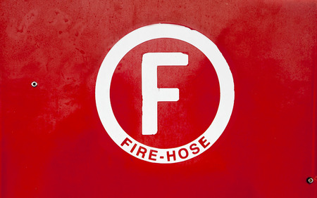 Fire hose symbol handmade on red painted background