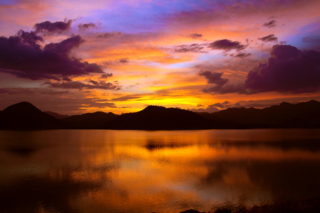 spectacular landscape with quite lake and mountains with sunset lightingの写真素材