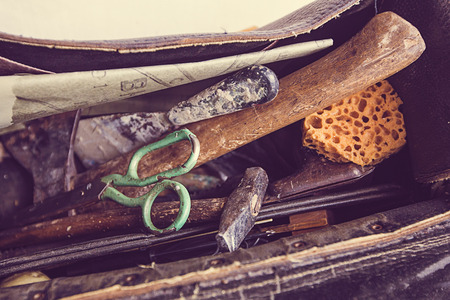 vintage look of an open case with old craft tools insideの写真素材