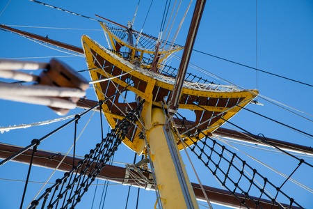 authentic sailing ship mast against blue skyの写真素材