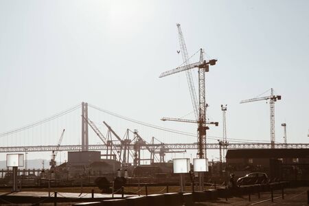 Modern industrial waterfront on the banks of a large river in sunset lightingの写真素材