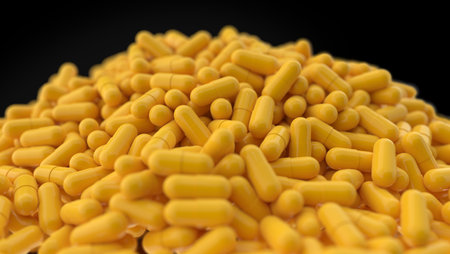 Heap of trendy yellow pills close up isolated on black