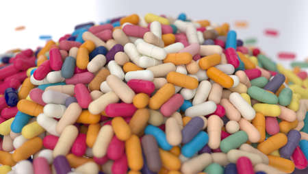 huge heap of different colors pills close up isolated on whiteの写真素材