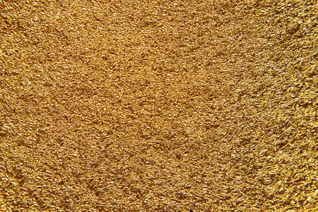 festive shiny background with close up texture of crumpled golden foilの写真素材