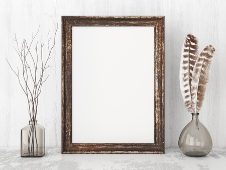 Vertical vintage poster mockup with wooden frame, feathers and twigs on empty white wall background. 3D rendering.の写真素材