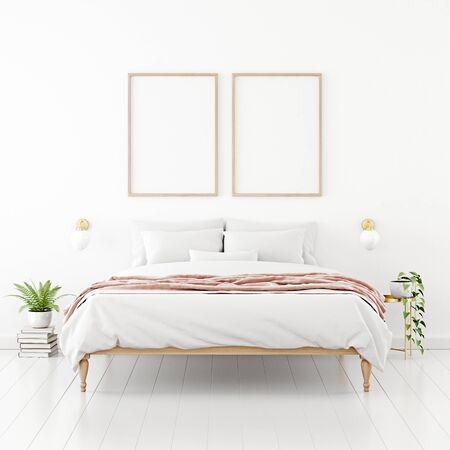 Poster mockup with two vertical wooden frames hanging on the wall in bedroom interior with unmade bed, pink plaid and green plants on empty white background. 3D rendering, illustration.の写真素材