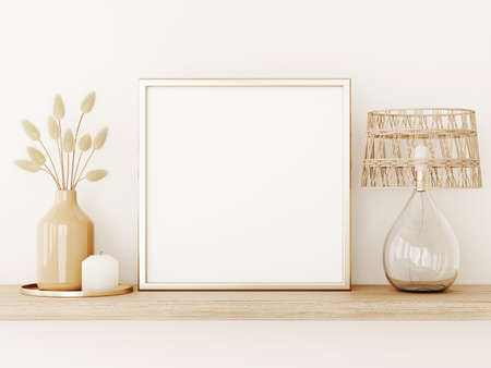 Poster art mockup with square gold metal frame, dried grass in vase, wicker lamp and candle on empty...