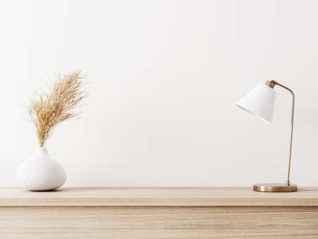 Room interior wall mockup in warm neutal minimalist style with biege wooden console, dried pampas grass and brass metal lamp on empty white background. Close up view, 3d rendering, 3d illustrationの写真素材