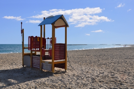 children s playground on the beach with the sea on the backgroundの写真素材