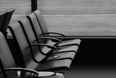 few empty chairs in the lounge area of an airportの写真素材