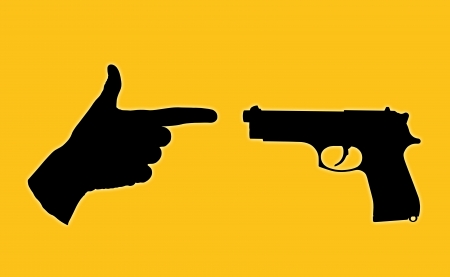 symbol of an unequal battle between a true gun and a human hand with fingers set in a pistolの写真素材