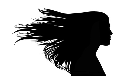 profile of a young beautiful woman with long strait hair waving in the windの写真素材