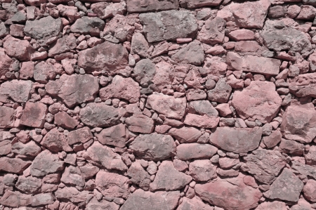 vinous old wall made of big and little rough stones without cementの写真素材