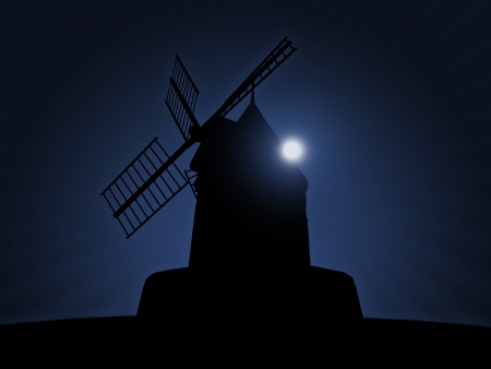 black silhouette of a beautiful old windmill on night sky background with the full moon risingの写真素材