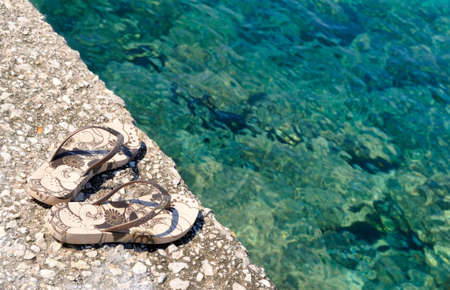 the pair of shoes by the seaの写真素材