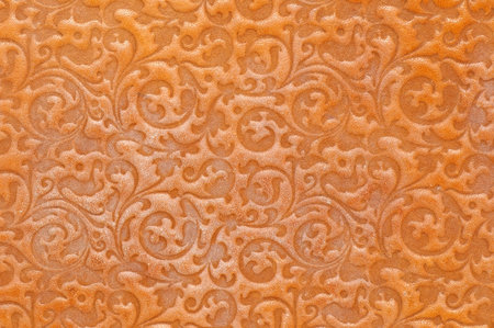 rubbed leather texture with floral ornamentの写真素材