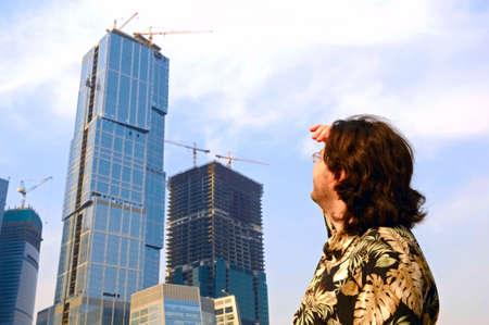 the man is looking on construction of business centre, Russiaの写真素材