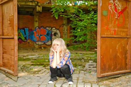 girl are waiting in the old yardの写真素材