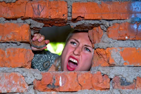 girl screaming behind the wall