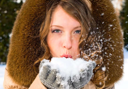 portrait of young smiling woman with snow