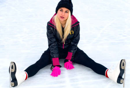 young blonde woman in skates on iceの写真素材