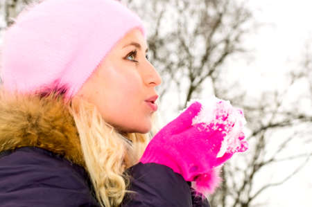 young woman blowing snow