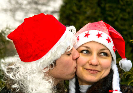 young kissing couple in red caps の写真素材