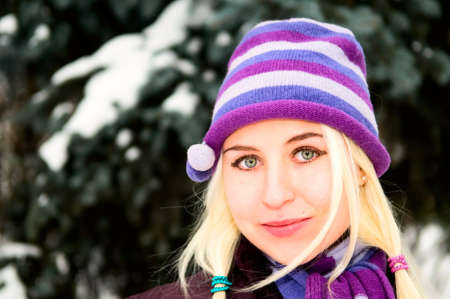 pretty blonde girl in winter forestの写真素材